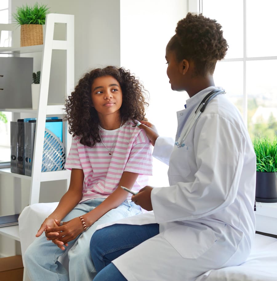 Teenager speaking with a doctor, both seated